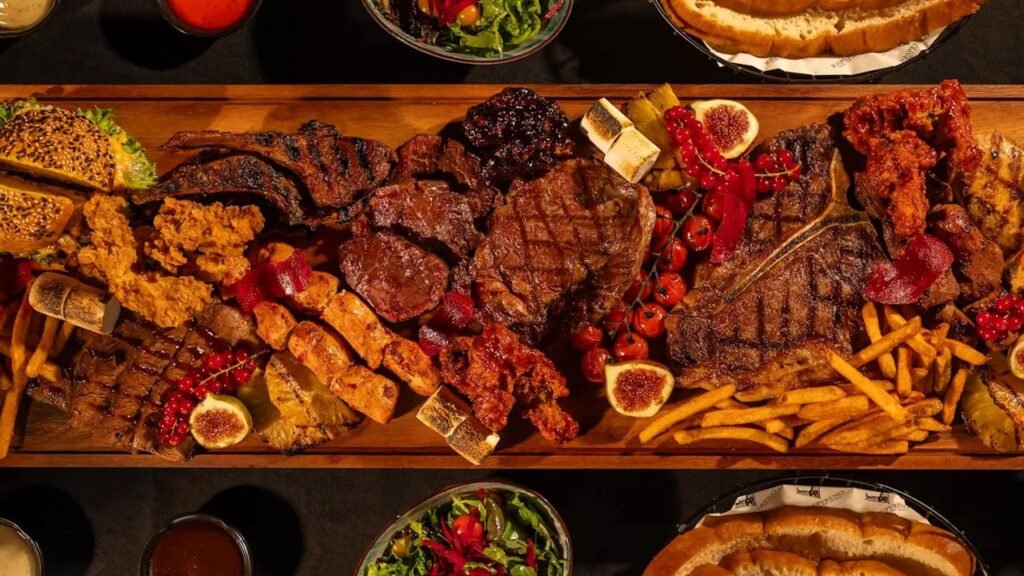 Juicy grilled steak served with crispy fries on a plate at a steakhouse.